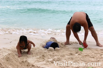 Burying in white sand, Boracay beach paradise