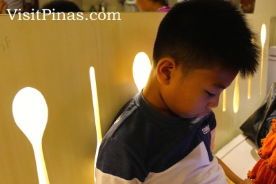 Lighted spoon shapes on chairs at Wooden Spoon